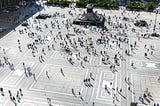 A European city square full of people, creating patterns of flows and interactions