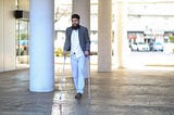 Man with neuromuscular disorder using walking sticks outdoors — Invitae genetic testing blog