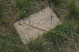 Photo of a gravestone with the name “unknown” carved into it