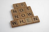 Several scrabble letters arranged to read: “if not now, when”.