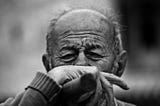 Black and white photo of a distressed elderly man