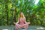 girl doing meditation in a garden