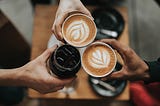 3 people holding Coffee Cups as a symbol of teamwork