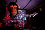 Monkey wearing a space suit and pointing towards the stars.