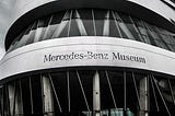 Black and white pic of the front of a Mercedes-Benz Museum.