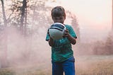 Little boy holding a soccer ball