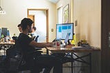 Person at desk sitting in front of computer