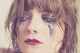 Woman with smudged make-up, implying she’s been crying