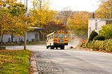A school bus drives down a street.