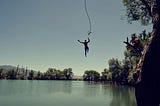 a person jumping into a lake