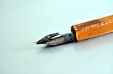 A pencil with a sharpener on the end.