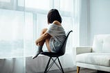 Woman sitting on chair looking depressed