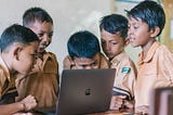 Children at school watching laptop