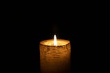 one candle with a sturdy flame