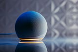 Photo of Amazon’s Echo product on a table with a shadowy background