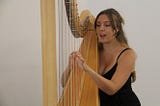 Angelina Egerton playing the harp at Manchester Jazz Festival