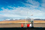 a photo of a gas pump with mountains behind it