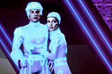 Tron and Yori embrace in the digital world of 1982’s Tron.