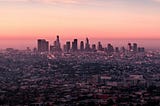 The Los Angeles city skyline at sunset.