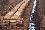 A peat bog that has been cut and drained — brown peat across the landscape