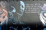 A graffiti street art featuring Martin Luther King quote on skin colour
