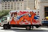 A picture of a moving truck with a colorful mural on it.