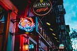 The outside of a pub with a sign of “Guinness” Beer