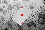 Ace of hearts against a background of blurry cards