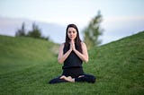 A woman sitting and doing breathing exercise — 4 breathing exercises that can change your life!