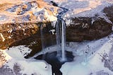 Beautiful Seljalandsfoss Waterfall with Snow in Winter in Iceland Without People