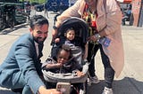 Zohran Mamdani taking selfie with a mom and two kids in Harlem, September 2025