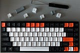 Keyboard with key puller and extra key caps