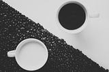 Yin/Yang Image of two cups, one with black liquid and one with white.