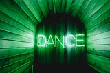 Image of tunnel all in green with the word “DANCE” in the middle of the image in white. Photo by Georgia de Lotz on Unsplash
