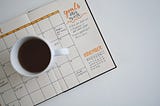 Cup of coffee on a monthly planner