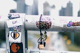 a metal railing with locks on it. Atlanta skyline in the background