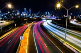 highway roads illuminated at night by cars and street lights