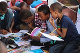 Students looking at magazines in the classroom.