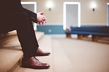 Image of man sitting on a bench in a train station