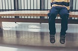 Child sitting on bench.