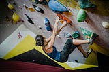 A Woman Walks Out of a Climbing Gym