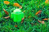 Android figurine in green grass