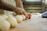 Photo of a man’s hands rolling balls of dough because that’s pretty much the sexiest thing ever.