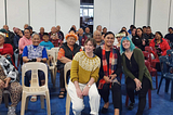 Left to right in front row: Rachel Dickerson, Jaye Moors, and Olivia Gray. Community engagement event at the Pukapuka Community Centre in Māngere, a suburb of Auckland.