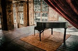 A grand piano alone in a room