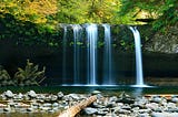 image of falling foss and waterfall in a serene surrounding of greenery