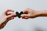 Picture of 2 people holding a heart