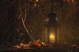 a lantern outside a house in a forest