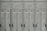 Four grey school lockers.
