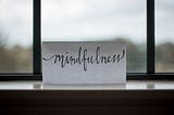 A piece of paper in the window that says, “mindfulness.”